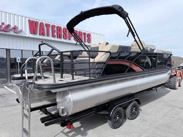 A Sun Tracker pontoon boat with a Yamaha outboard motor labeled '60' parked at a dealership lot.